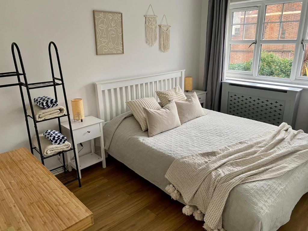 a bedroom with a bed and a chair and a window at 3 Bedroom House 2 stops from London Bridge in London