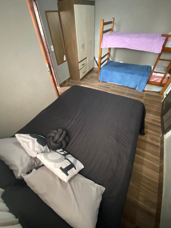 um pequeno quarto com uma cama e 2 beliches em Alugo espaço com piscina + Jacuzzi! em Mogi das Cruzes