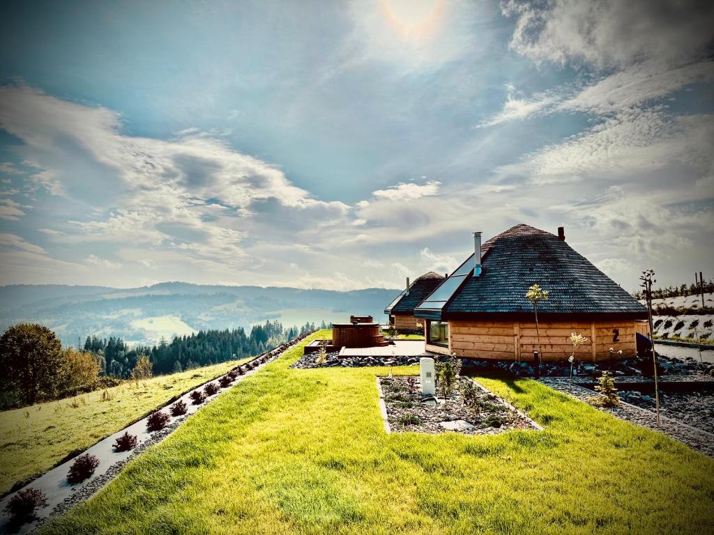dom na szczycie wzgórza z zielonym polem w obiekcie Heavenly Houses - Niebiańskie Domki w mieście Jaworzynka