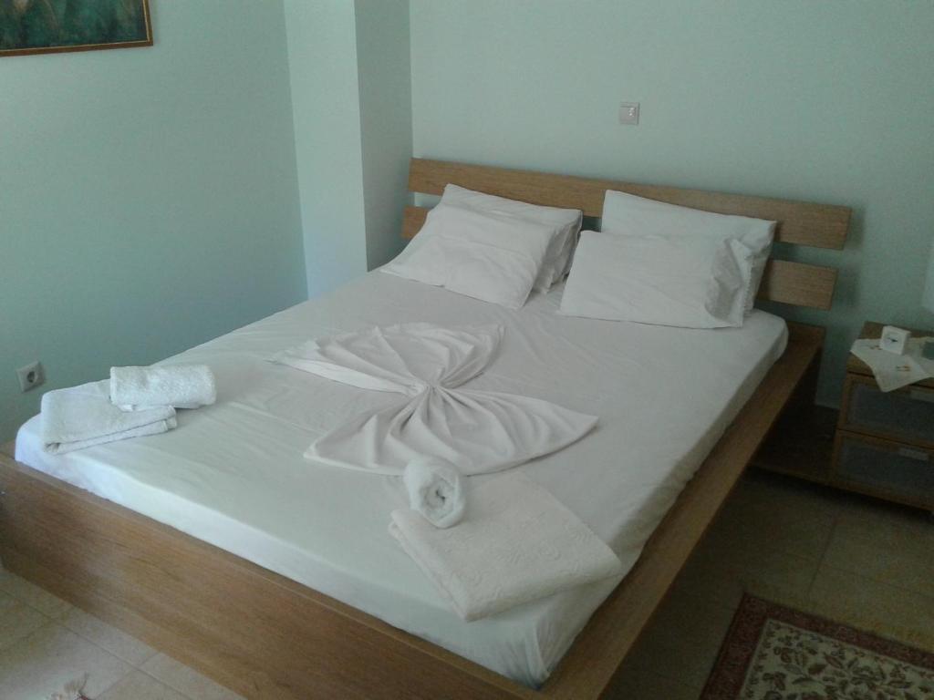 a large white bed with towels on it at Spiro's Apartment in Lefkada Town