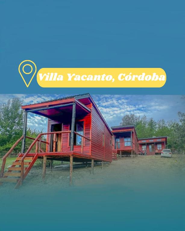 a row of red houses in a field at Refugios del Monte in Villa Yacanto