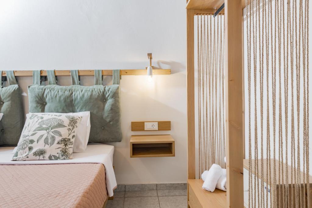 a small bedroom with a bed and a lamp at Sunset Apartments in Tsilivi
