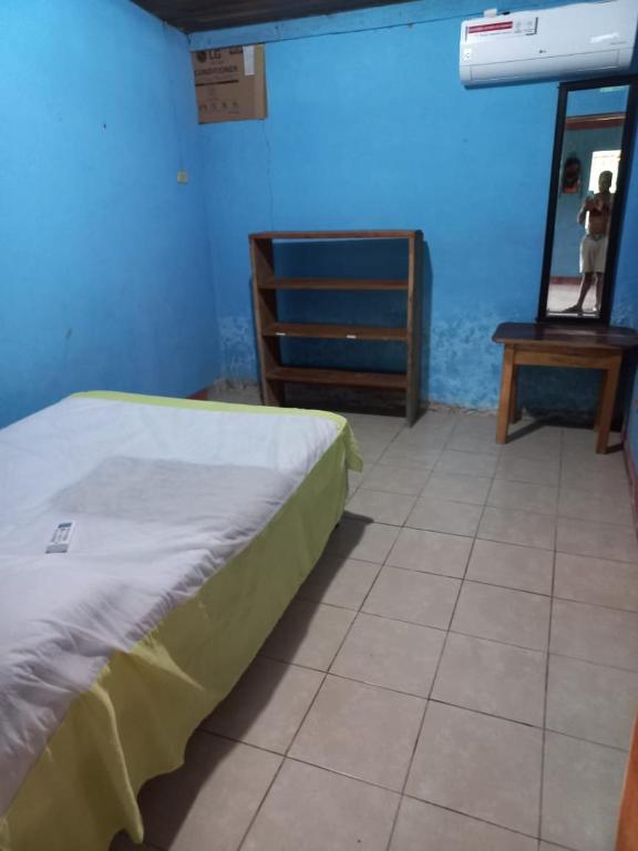 a bedroom with a bed and a dresser and a mirror at Cabinas Chavez in Rivas