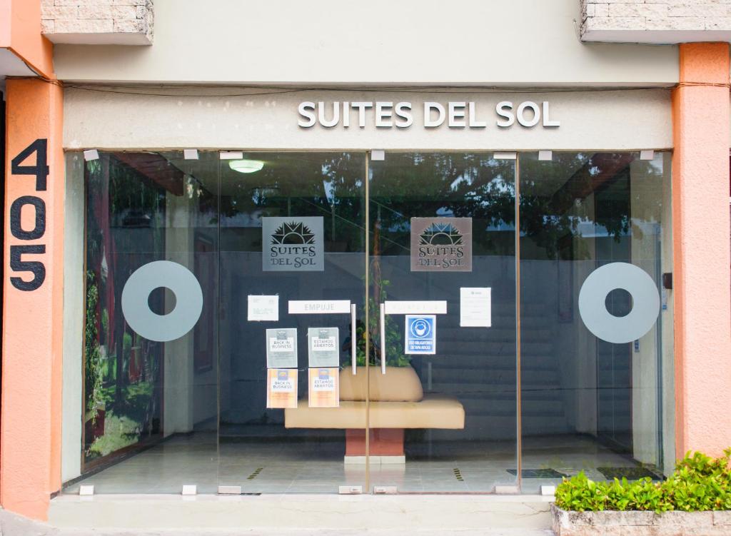 a store front window of a store with signs on it at Suites del Sol Hotel & Apartments in Mérida