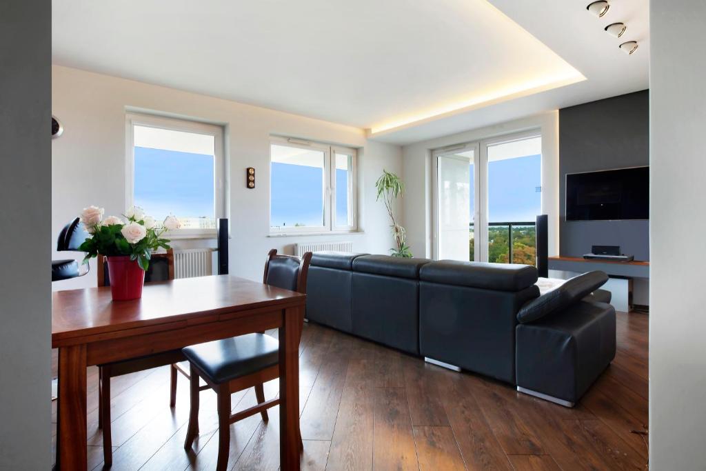 a living room with a couch and a table at Elite Apartments Seaview Tower in Gdańsk