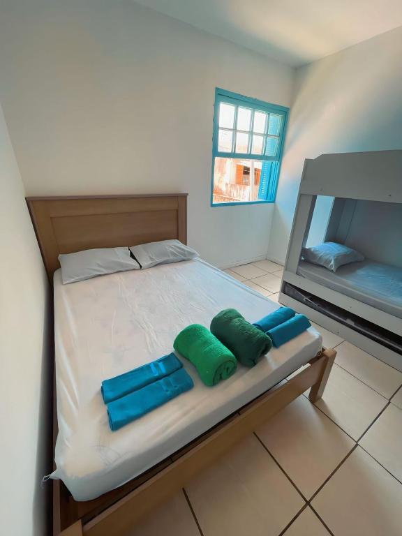 a bedroom with a bed with two pillows on it at Hospedagem Riccetti´s - Consulado Americano in Sao Paulo