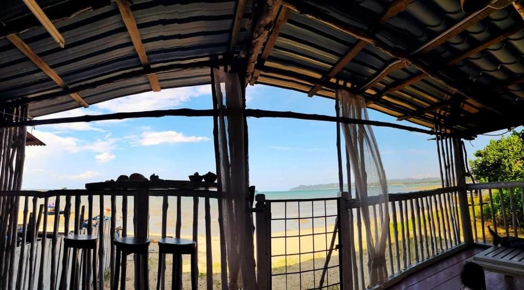 a room with a balcony with a view of the ocean at Bluewave Sea Out Seaview Homestay in Kuah
