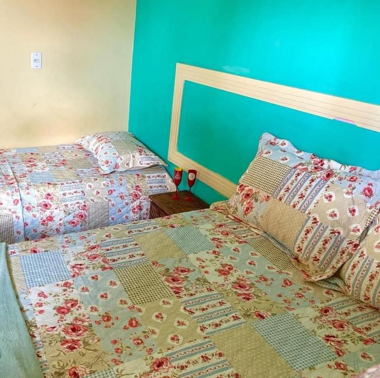 two beds sitting next to each other in a bedroom at Chalé Estrela do mar 2 in Galinhos