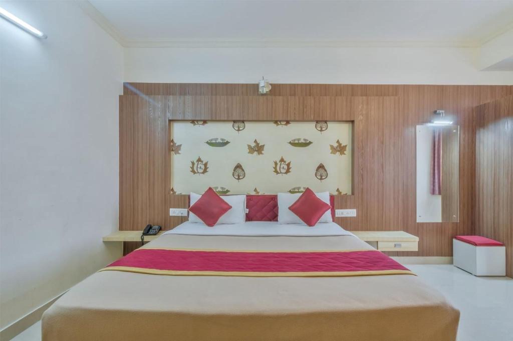 a bedroom with a large bed with red pillows at OYO Flagship 81536 Royal Classio in Bangalore
