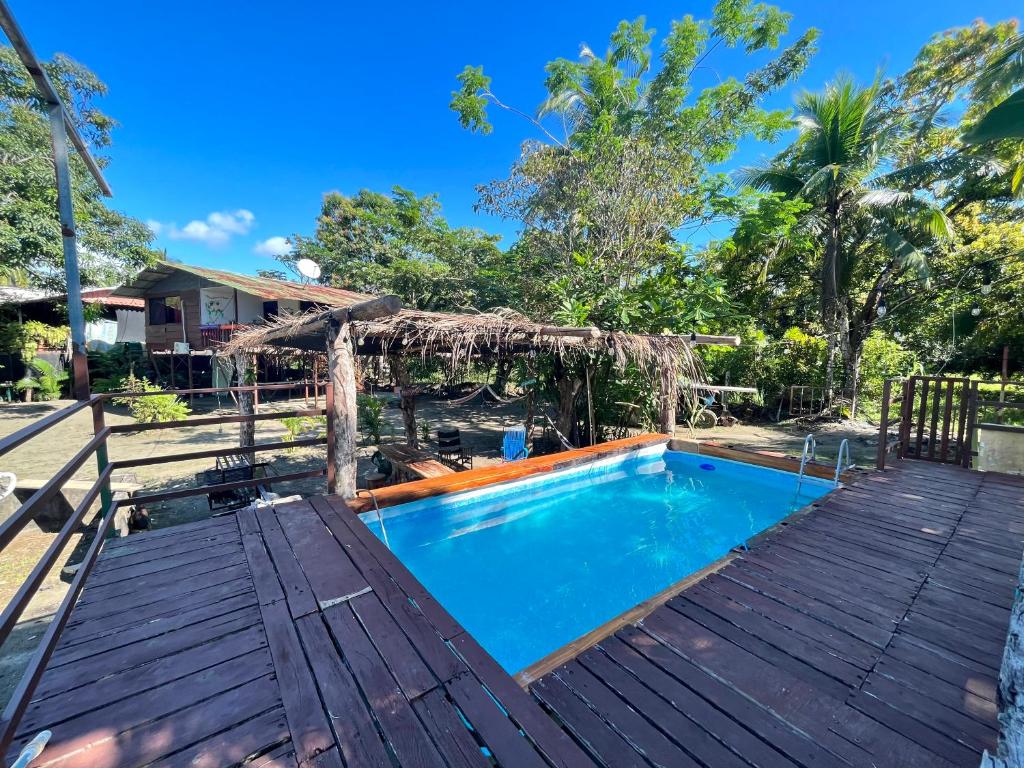 a swimming pool on a deck next to a house at Casa Tili TicoExperience on IslaDamas in Quepos