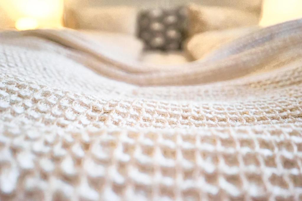 a close up of a white blanket on a bed at Doppelzimmer mit Terrasse in Därligen