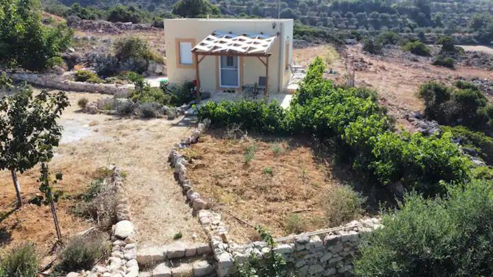 a small house with a solar roof on a hill at Damianakis Village Rethymno in Somatás