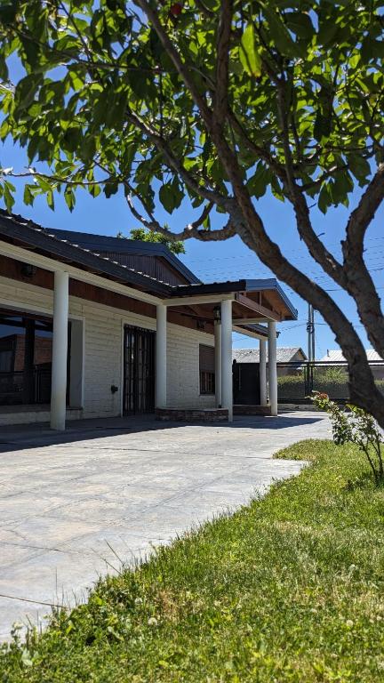 a building with a tree in front of it at Casa Pampa in Sarmiento