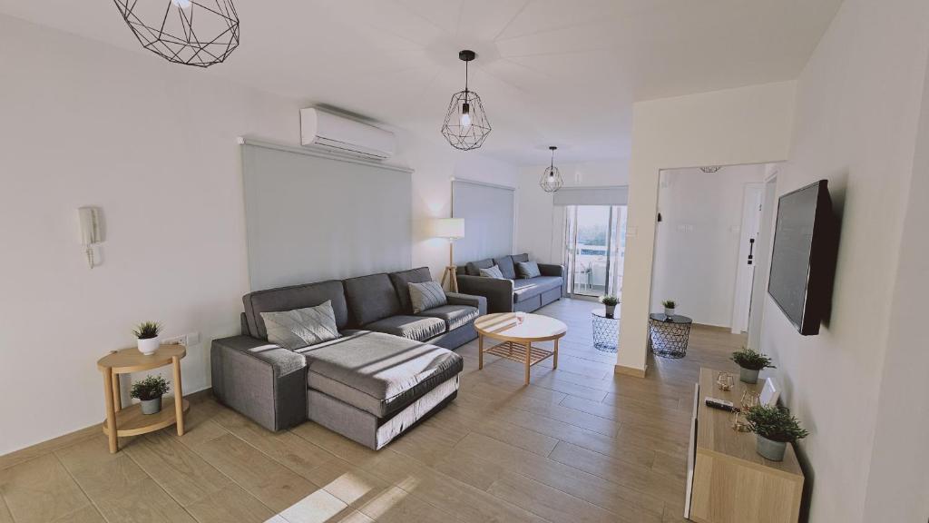 a living room with a couch and a table at STAY Sky Apartment in Limassol