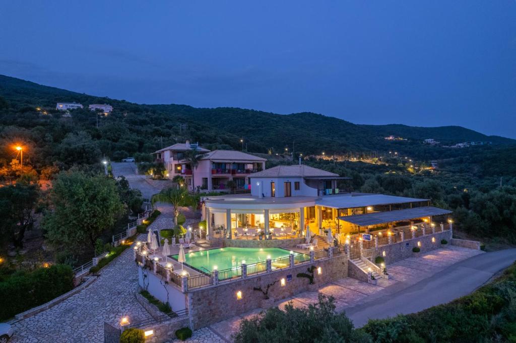 an aerial view of a house with a swimming pool at 3Aktes Suites & Studios in Syvota