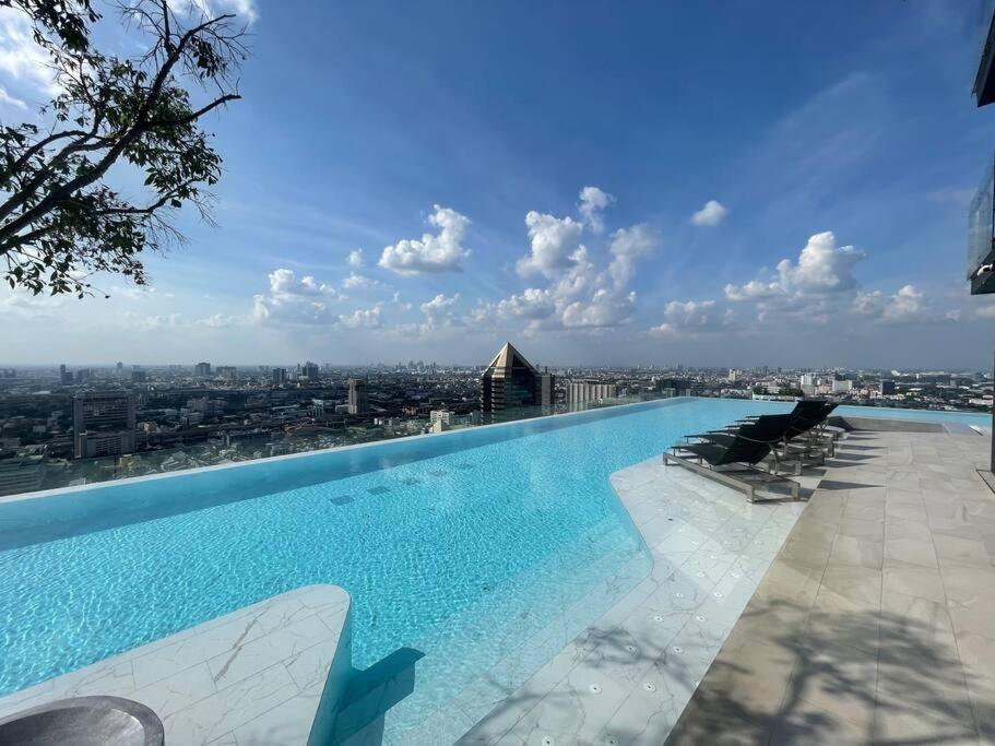 a swimming pool on the roof of a building at Knightbridge Space Ratchayothin in Ban Yang
