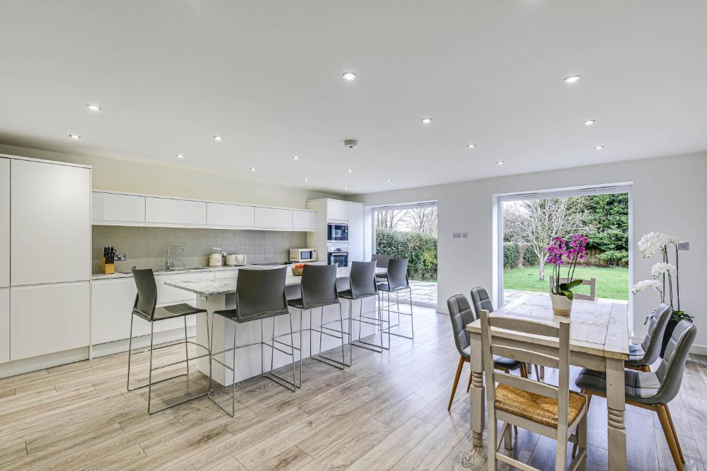 a kitchen and dining room with a table and chairs at Moselle House in Biggin Hill