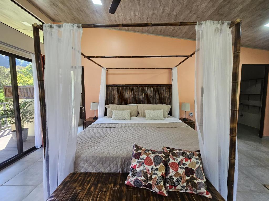 a bedroom with a bed with a canopy at CASITAS SELVARA in Platanillo