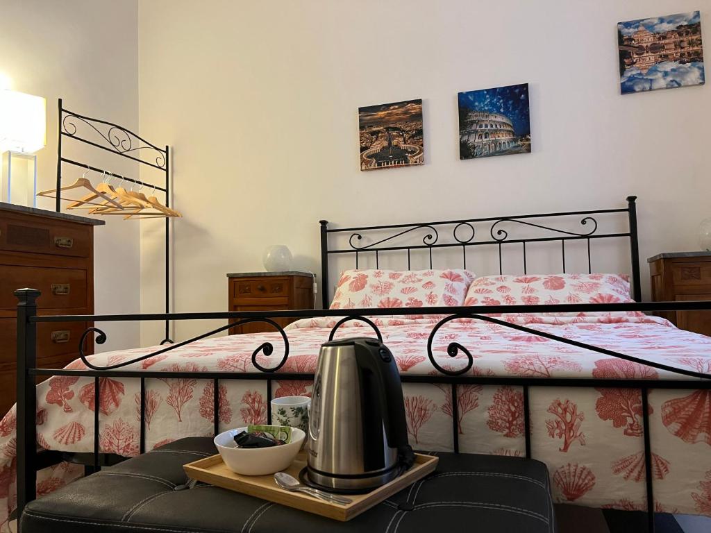 a bedroom with a bed with a tea kettle on a tray at Mio House Vatican in Rome