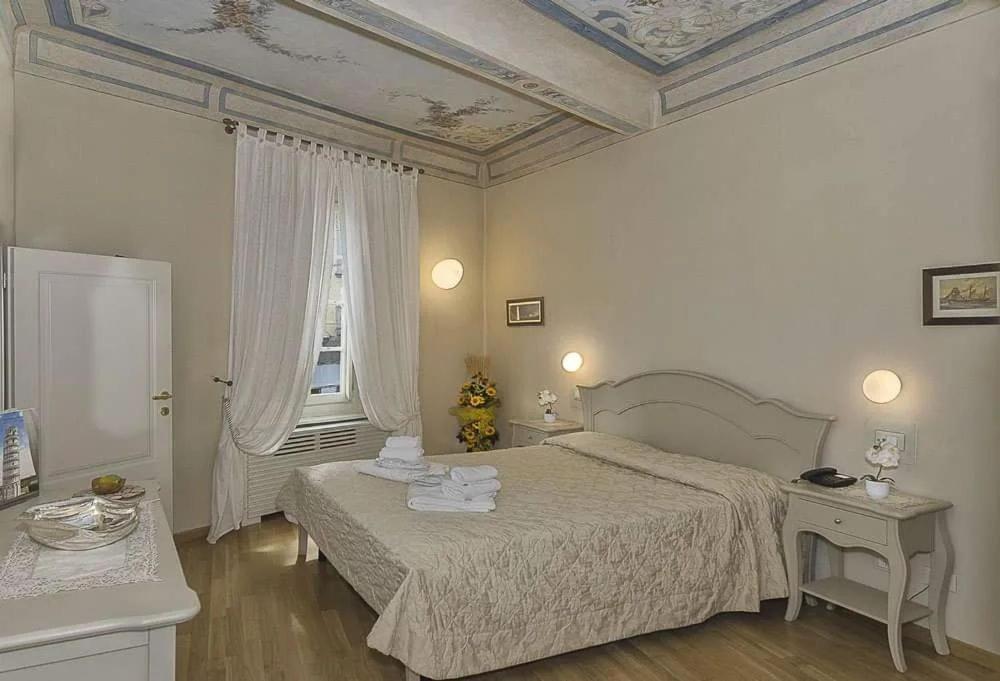 Postel nebo postele na pokoji v ubytování Residenza d'Epoca Relais I Miracoli
