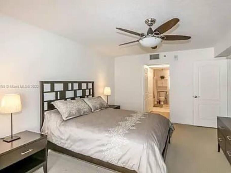 マイアミにあるAmelie Brickell modern Condo with Pool & Balcony & Gym & Free Parking & Bayview # Walk to Everythingのベッドと天井扇風機のある寝室