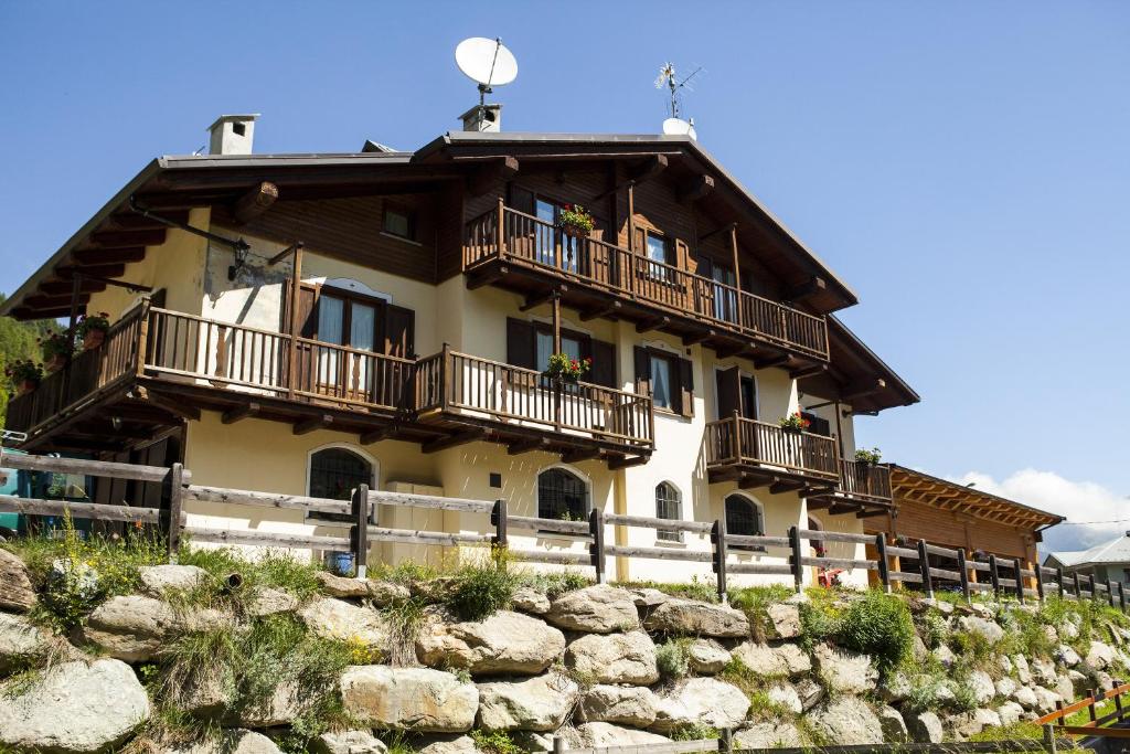 a large house with balconies on top of a hill at Casa Martin in Pragelato