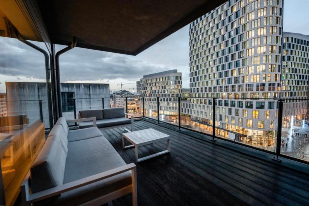 a balcony with a couch and a table on a building at Apartment with Stunning View in City Center in Brussels