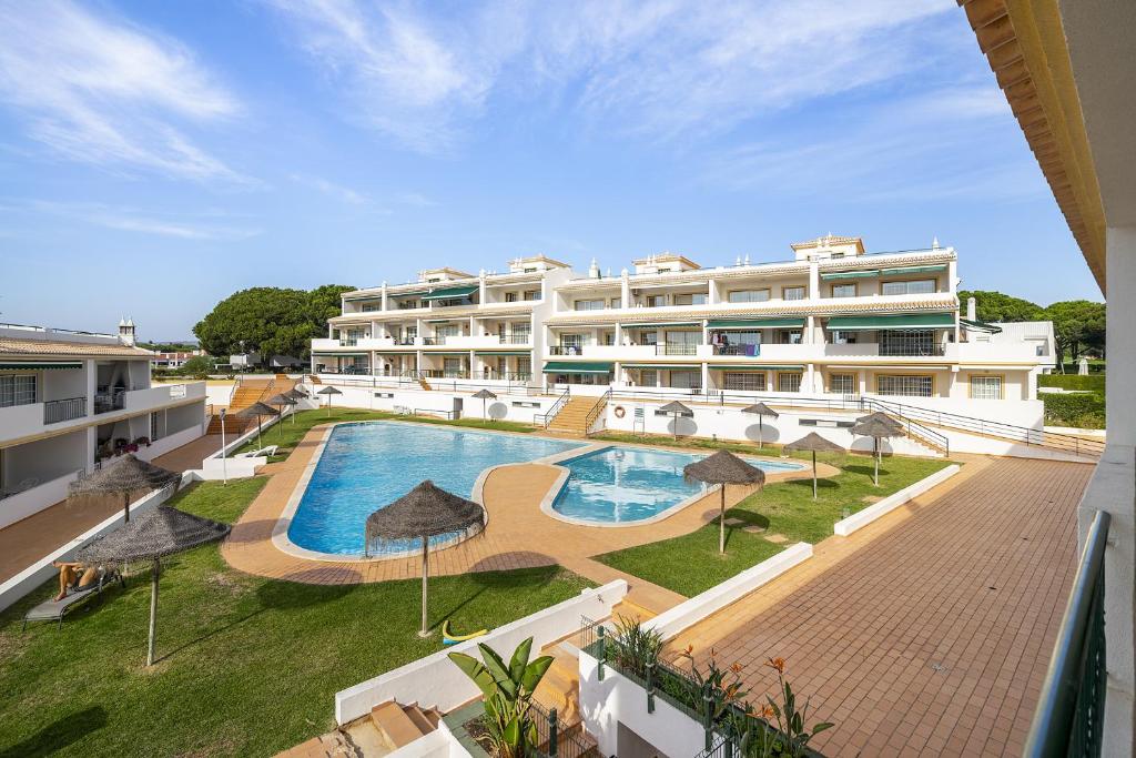 an external view of a hotel with a swimming pool at Vilamoura - Cozy and Quiet Holiday Apartment in Vilamoura