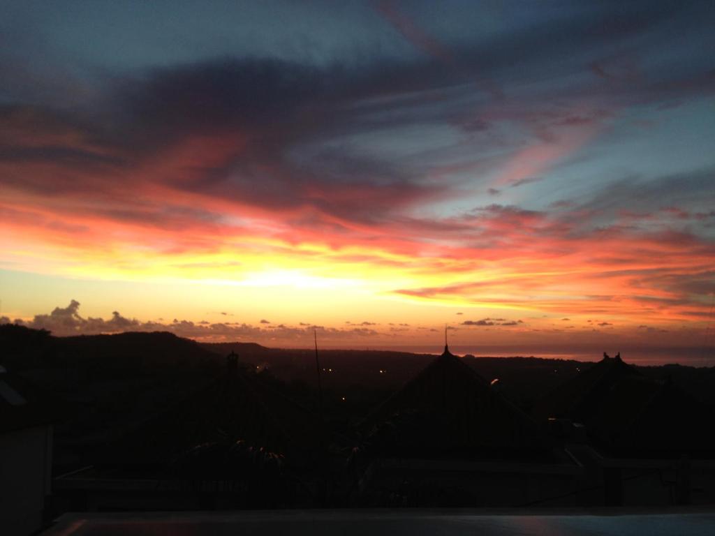 a sunset from the roof of a building at Villa Ultimo in Uluwatu