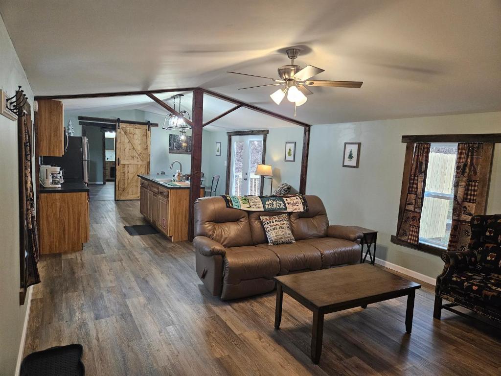 sala de estar con sofá y mesa en Grey Pines at Hocking Vacations, en Logan