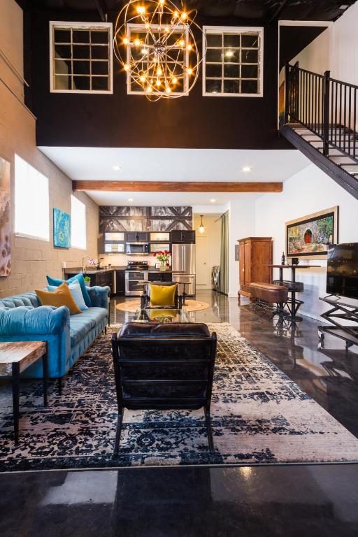 a large living room with a blue couch and a table at Petaluma Warehouse Lofts Unit D in Petaluma