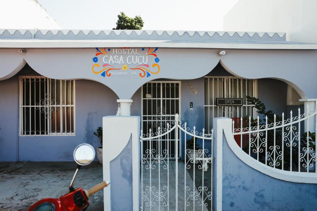 a scooter parked in front of a building with a gate at Hostal Casa Cucu - Wifi, Hot Water, AC, free water refill - Stay 3 nights or more and get 1 day free bikes & 1 free laundry wash in Valladolid