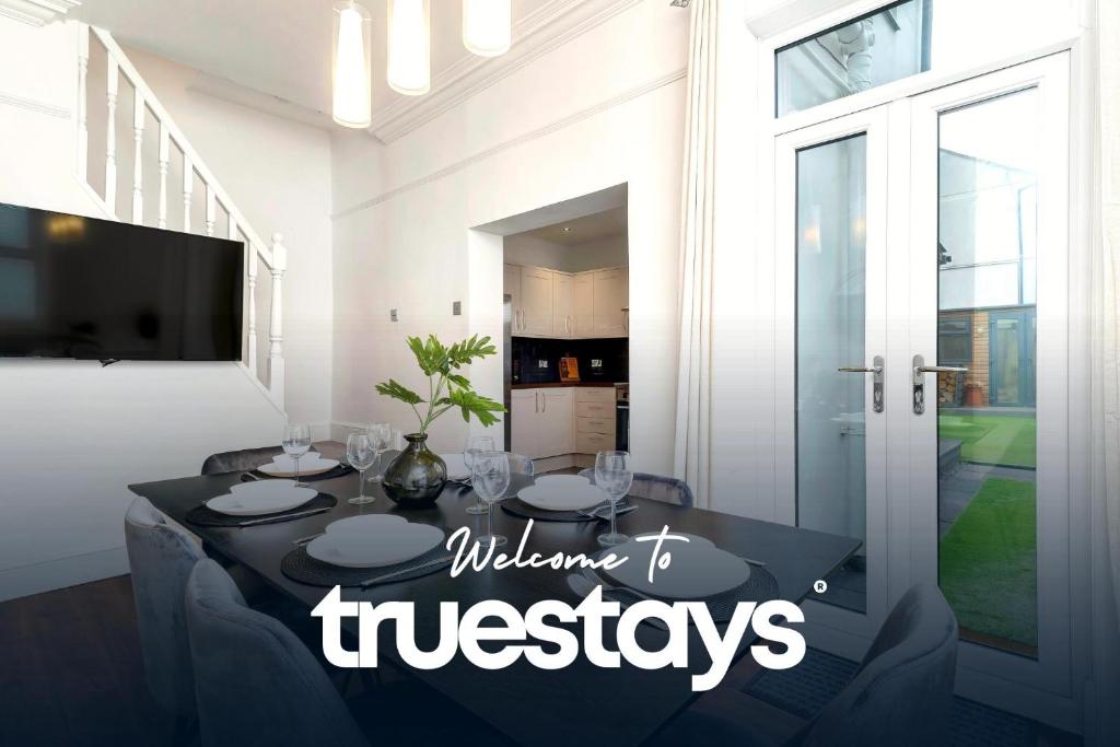 a dining room with a table with a welcome to trustees sign at NEW Lily House by Truestays - 3 Bedroom House in Stoke-on-Trent in Newcastle under Lyme