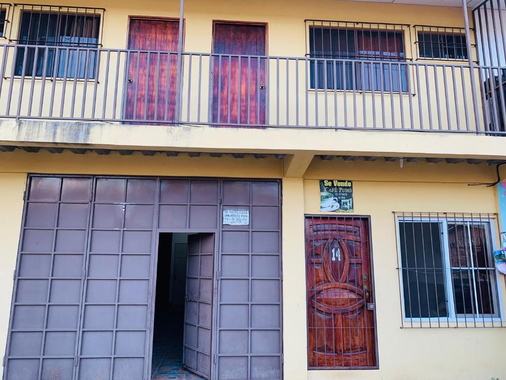a building with two doors and a balcony at Sucursal del Cielo in Concepción de Ataco