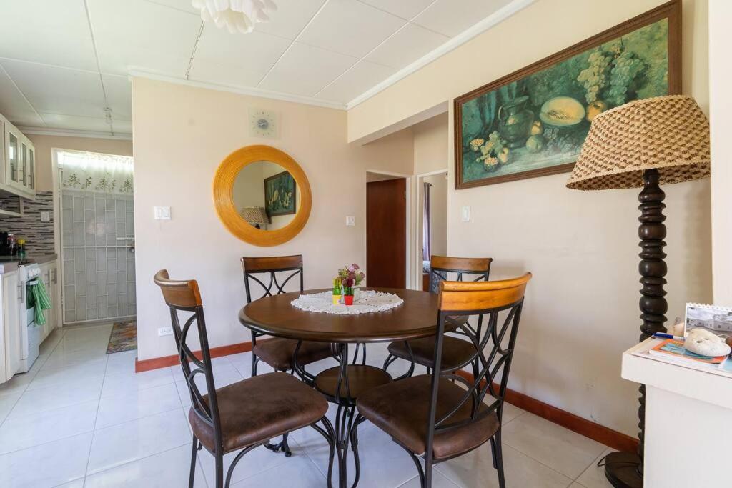 a kitchen and dining room with a table and chairs at Paddock Road in Bridgetown