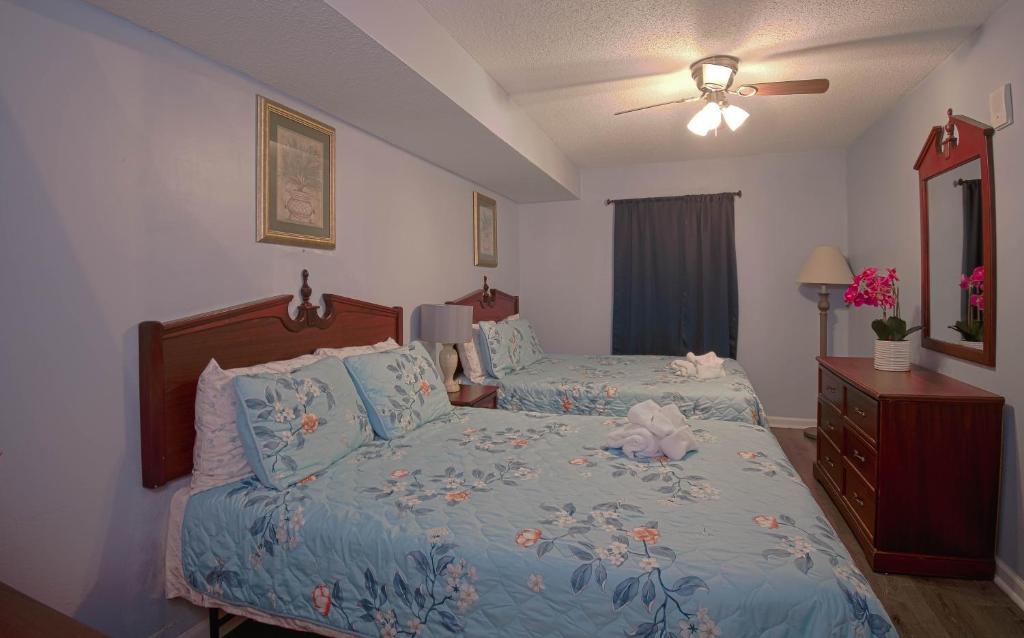 a bedroom with two beds and a ceiling fan at Atlantica Resort in Myrtle Beach
