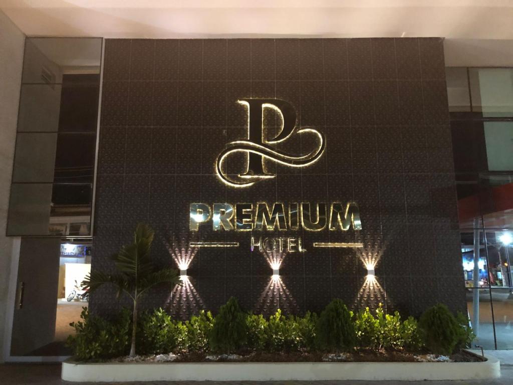 a building with a sign for a performing hotel at Premium Hotel in Delmiro Gouveia
