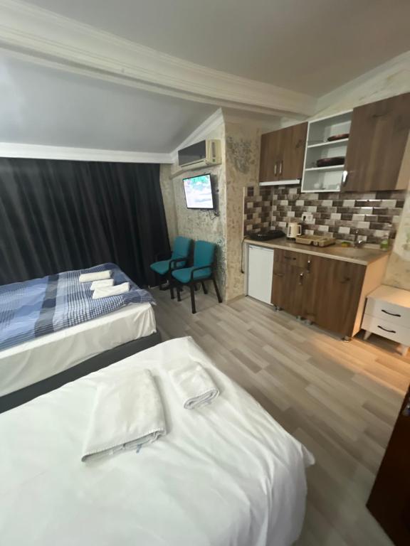 a hotel room with two beds and a kitchen at İstiklal hostel istanbul in Istanbul