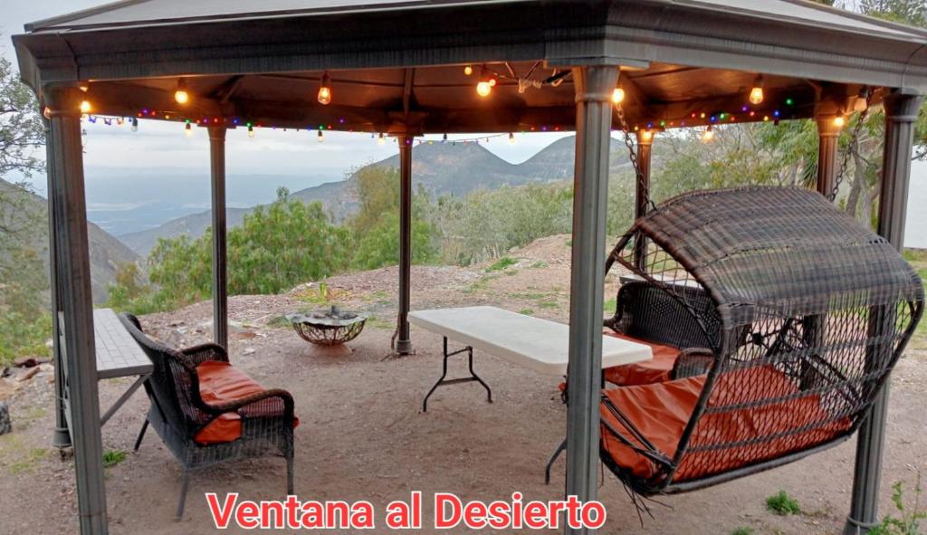 a gazebo with a picnic table and a table and chairs at Ventana Al Desierto in Real de Catorce