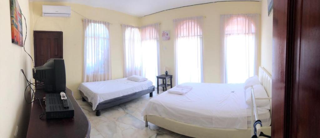 Postel nebo postele na pokoji v ubytování Veranera Hostal