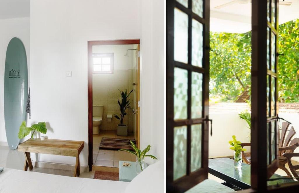 a room with a door open to a room with a surfboard at Neutral Wind Beach Home in Matara