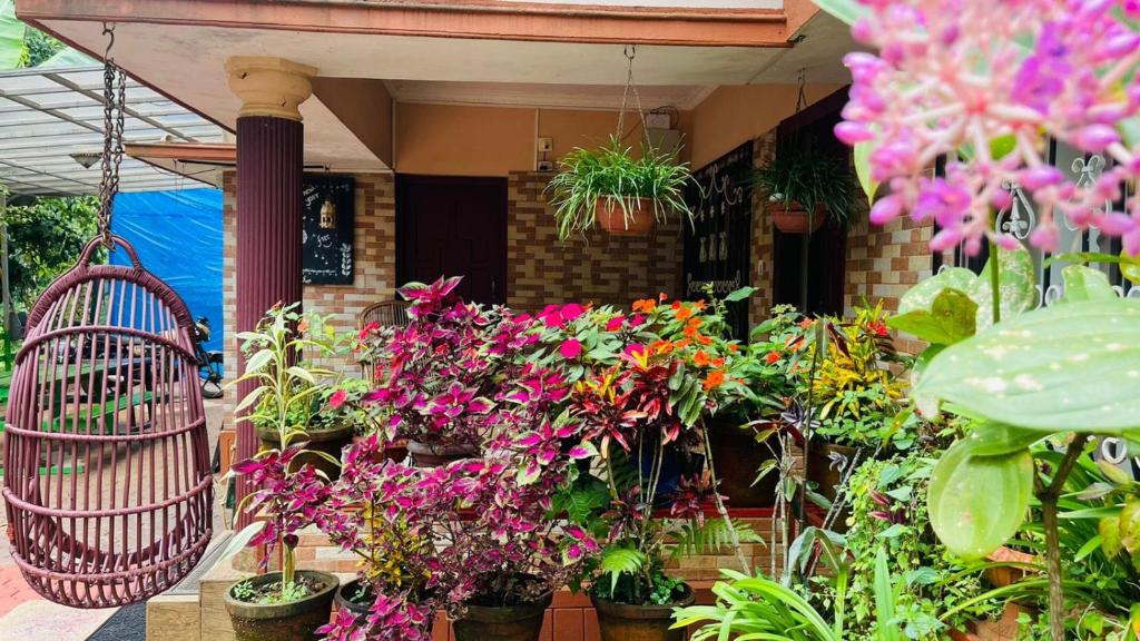 a bunch of flowers in front of a house at Lake View Cottage Wayanad in Tariyod