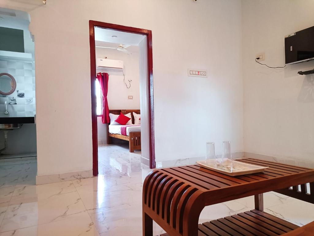 a room with a table and a living room at Rudra Villas in Rāmeswaram