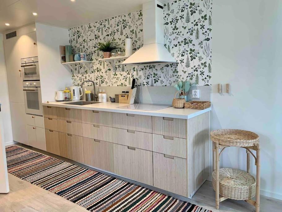 a kitchen with a sink and a counter top at Nybyggt boende nära hav och natur. in Störlinge