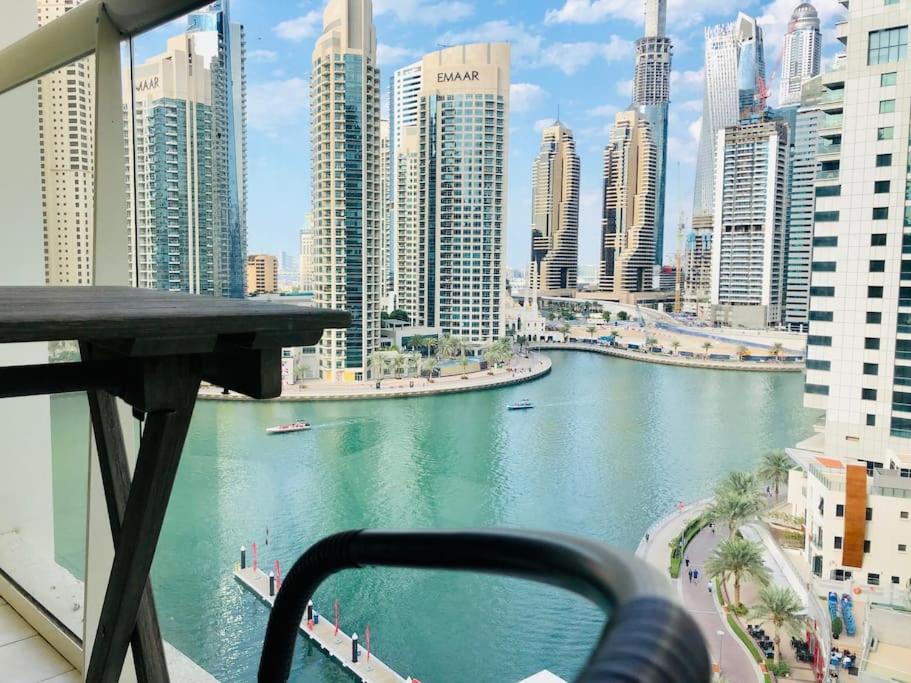 a view of a river in a city with tall buildings at Full sea view with balcony with 5 stars hotel exceptional entertainment - Studio Apartment - 10 min to JBR - in Dubai