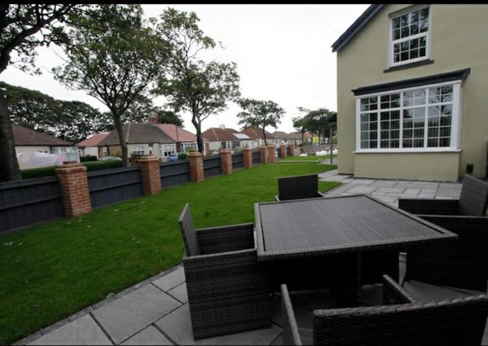 a patio with a table and chairs in a yard at Seaglass Cottage - Redcar in Redcar
