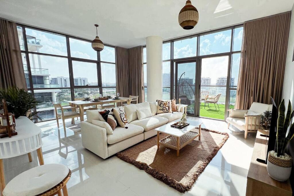 a living room with a couch and a table at Spacious Lux Golf View Apartment in Dubai Marina
