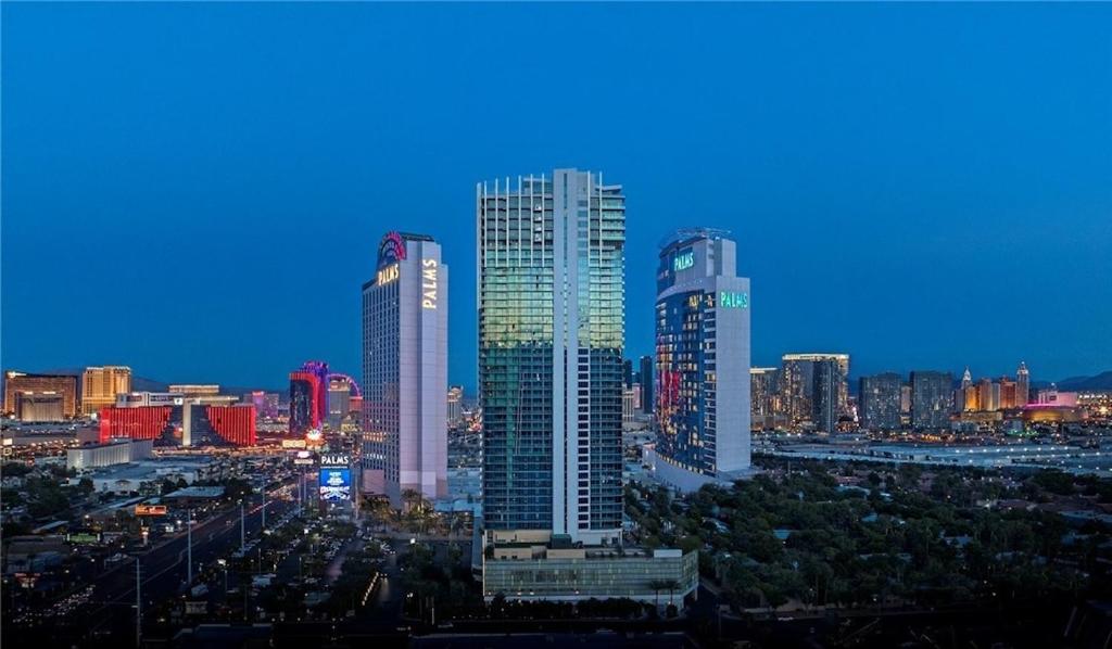 a group of tall buildings in a city at night at Palms Luxury Oasis Iconic Strip View w/balcony in Las Vegas