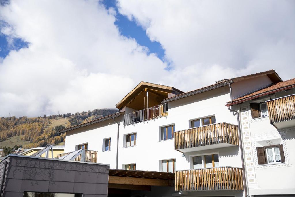 a white building with wooden balconies on it at Chasa Bagnera 174 in Scuol