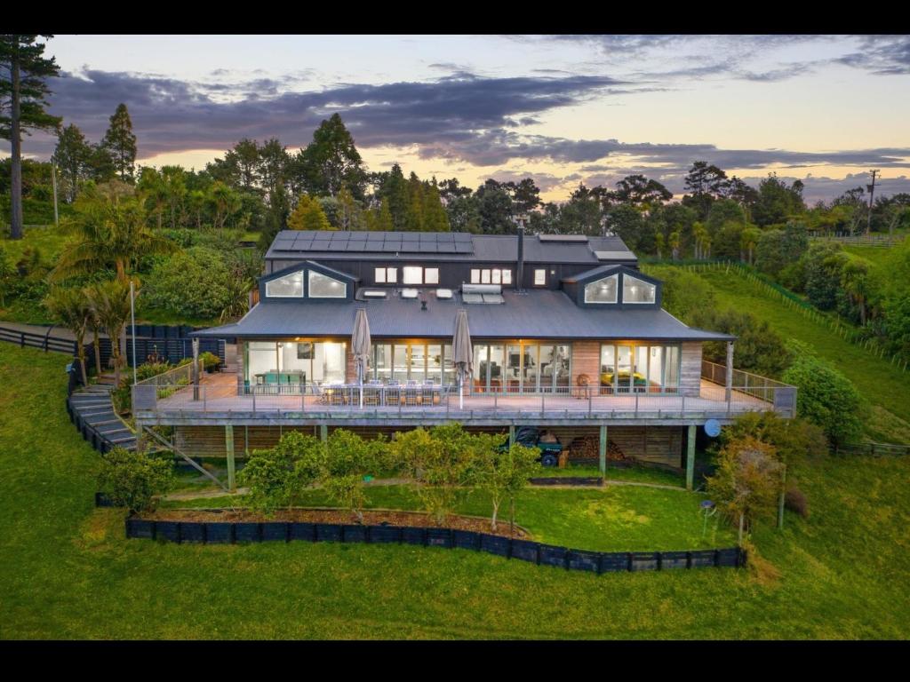 an aerial view of a large house on a hill at Sunshine Valley in Auckland